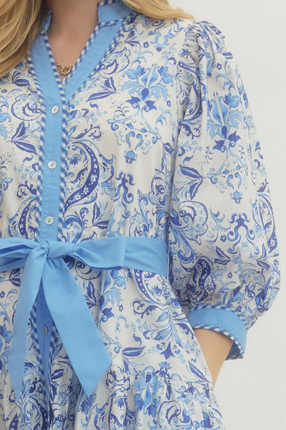 Royal Printed Long Sleeve Belted Dress: white with blue floral/paisley, blue trim, buttons, waist tie. Sizes: XS–XL.