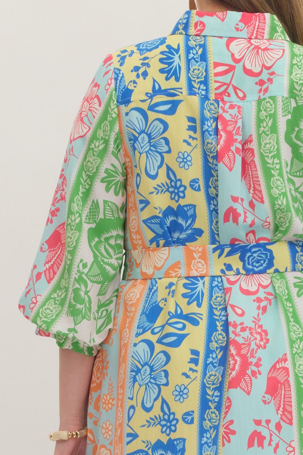 On Vacation Time Dress: plus size, elbow-length sleeves, belted waist, patchwork floral in blue/green/pink/yellow. Sizes 1X-4X.