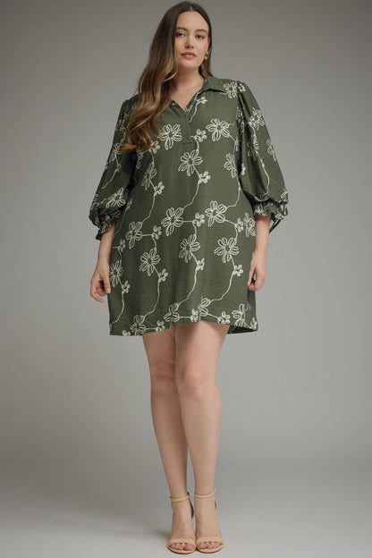 Olive Bloom Tie Waist Dress: olive green mini dress with white floral patterns, statement balloon sleeves, and waist tie for shape. Available in sizes XS–XL.