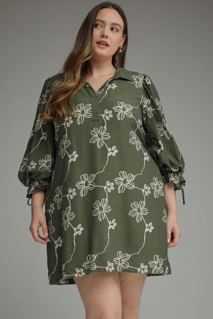 Olive green dress with white floral patterns, tie waist, and long balloon sleeves. Available in sizes XS-XL.