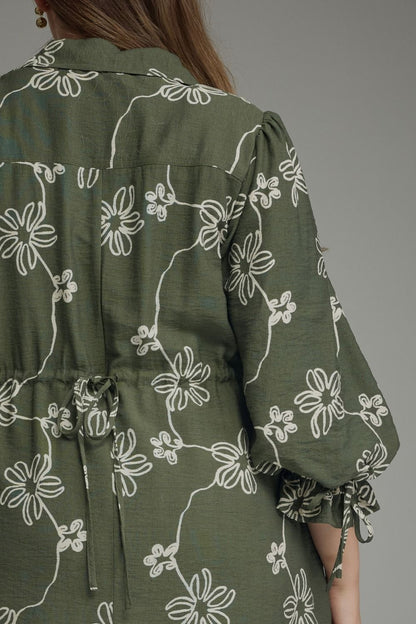 Olive Bloom Tie Waist Dress in olive green with white floral pattern, loose balloon sleeves, tie waist. Available in sizes XS-XL.
