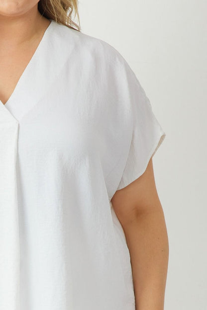 A solid maroon V-neck short sleeve top detailed with a sleek finish. Available sizes range from small to extra large.