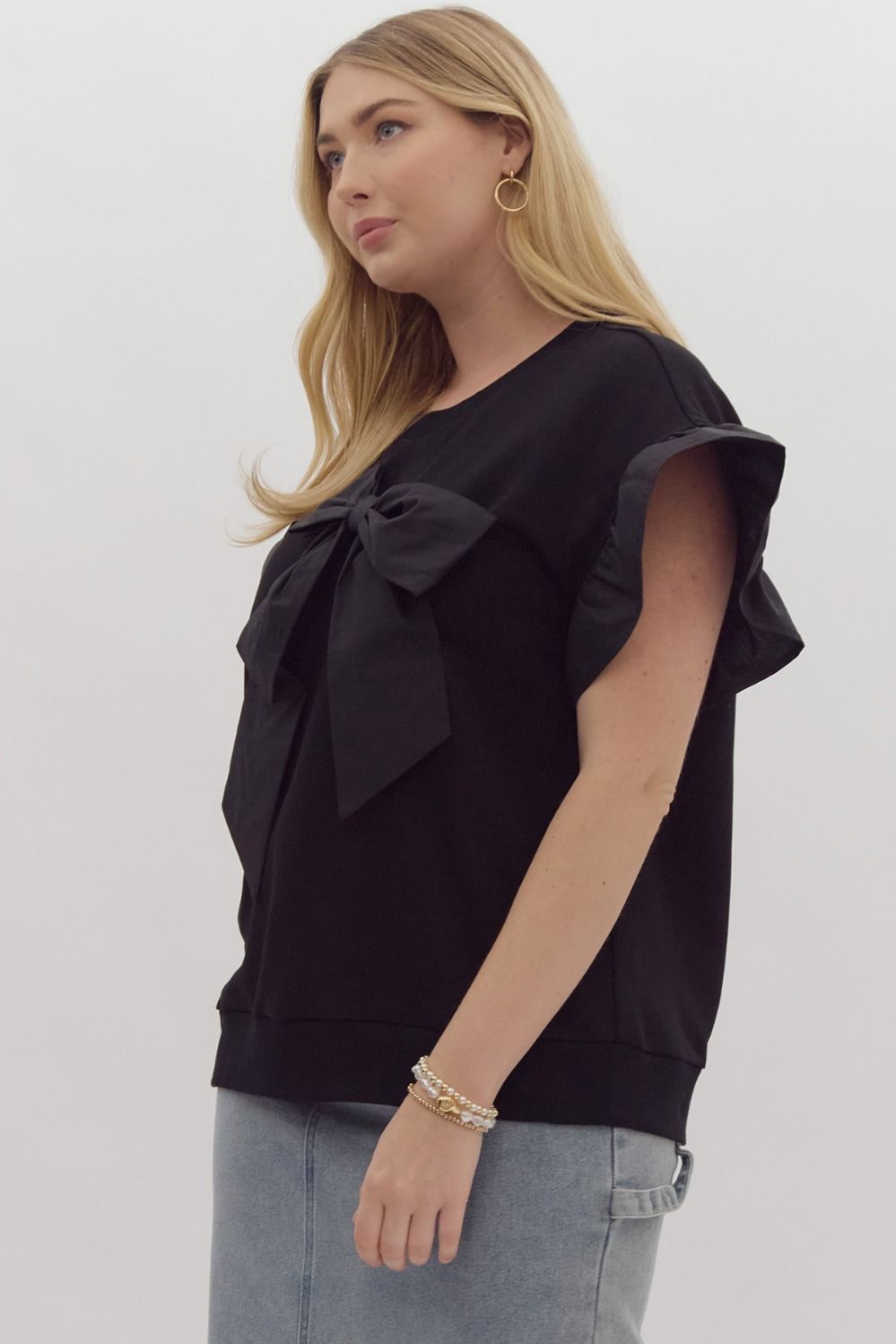 The Black Ruffle Sleeve Ribbon Top features elegant ruffle sleeves and a stylish ribbon detail. Available sizes: XS, S, M, L, XL.