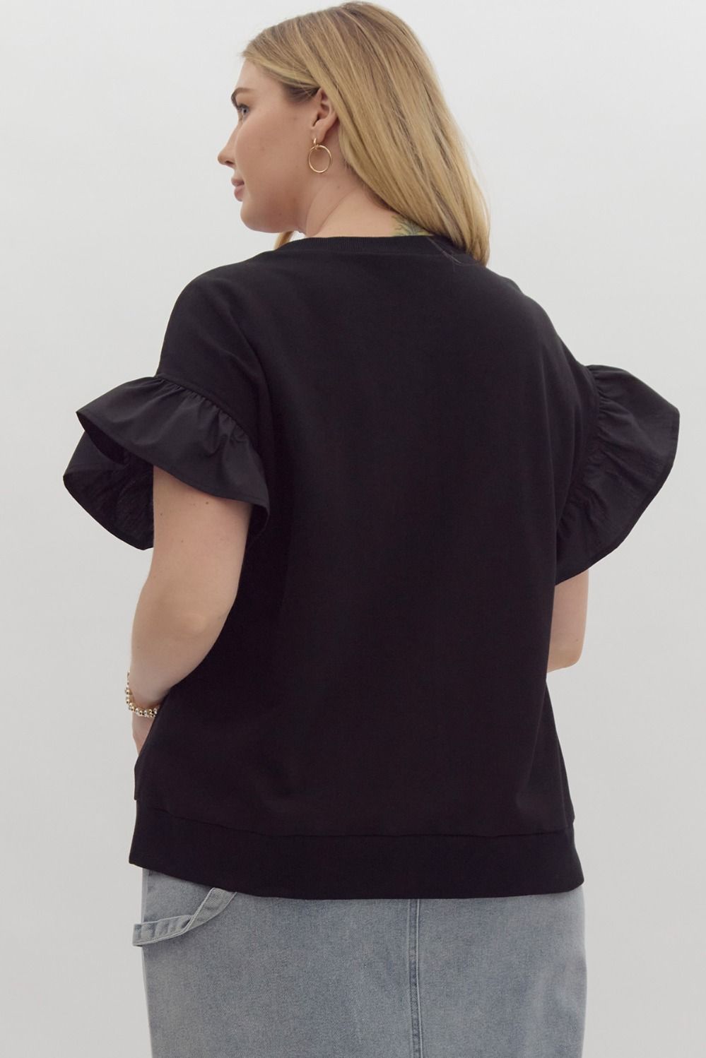 The Black Ruffle Sleeve Ribbon Top features elegant ruffle sleeves and a stylish ribbon detail. Available in sizes XS to L.