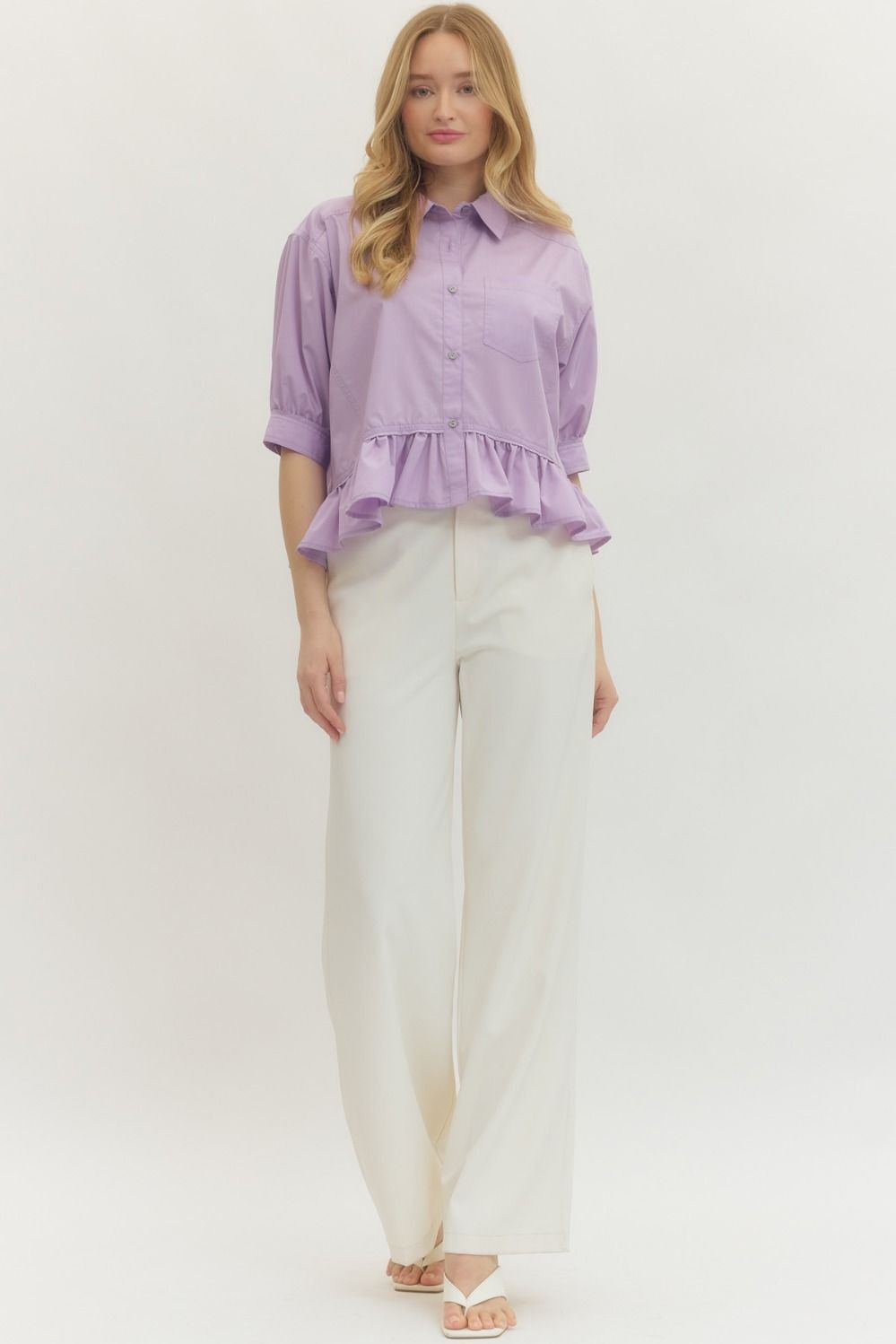 Lavender Ruffle Hem Button-Up Top with ruffle hem detail. Available in sizes XS-XL.