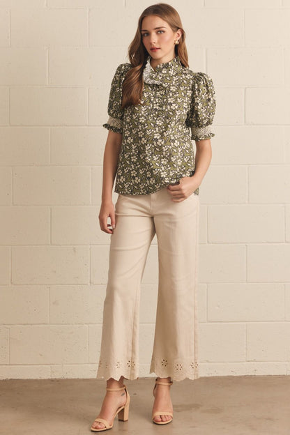 Willow Bloom Ruffle Top: green puff sleeve blouse with floral print and ruffle trim. Available in XS–XL.