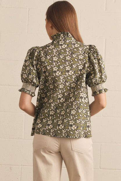 Willow Bloom Ruffle Top: green, floral print, ruffled details, puffed short sleeves. Available in sizes XS–XL.