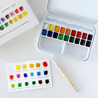 Watercolor paint set with 18 vibrant shades in a sturdy metal tin, includes paintbrush and color chart with swatches and names. Available in 18-color size.
