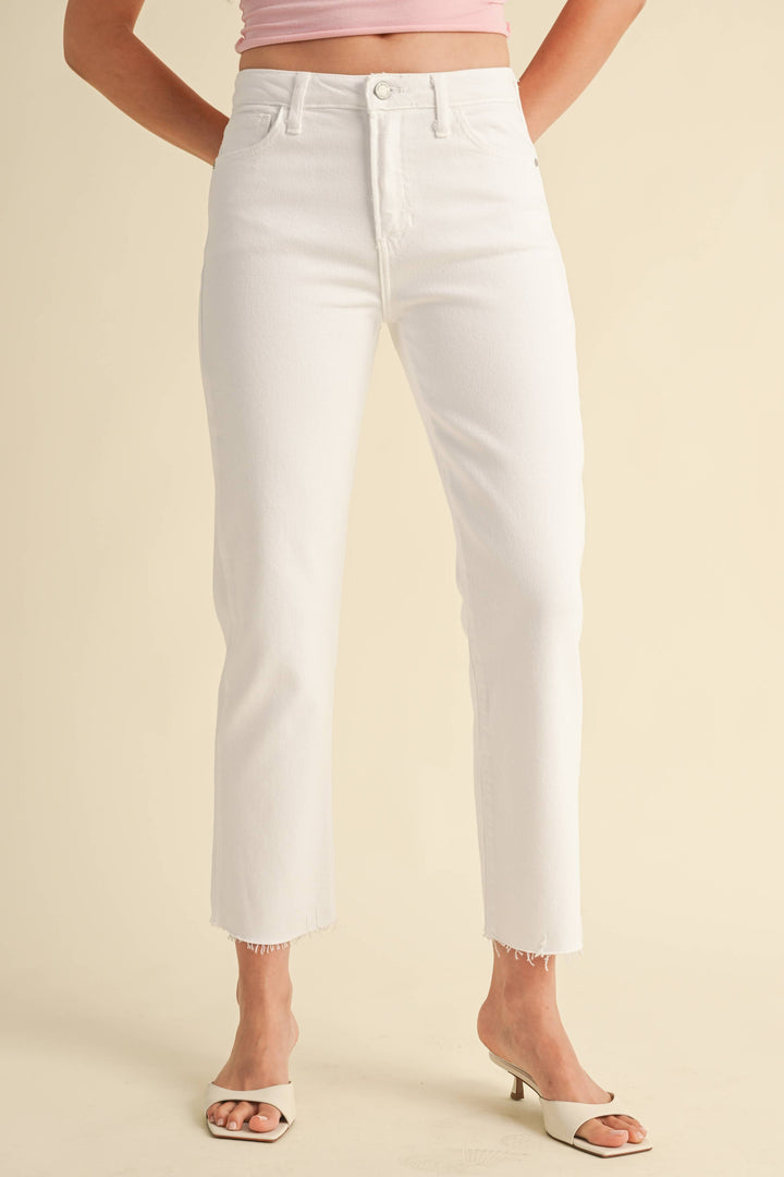 The Vintage Slim Straight Jeans in White: high rise, slim straight fit, raw hems. Sizes 24-32 available.