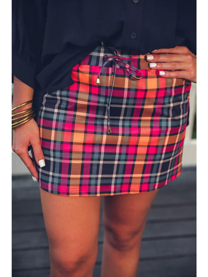 Patterned in Plaid Skort with elastic waistband. Available in sizes XS-XL.