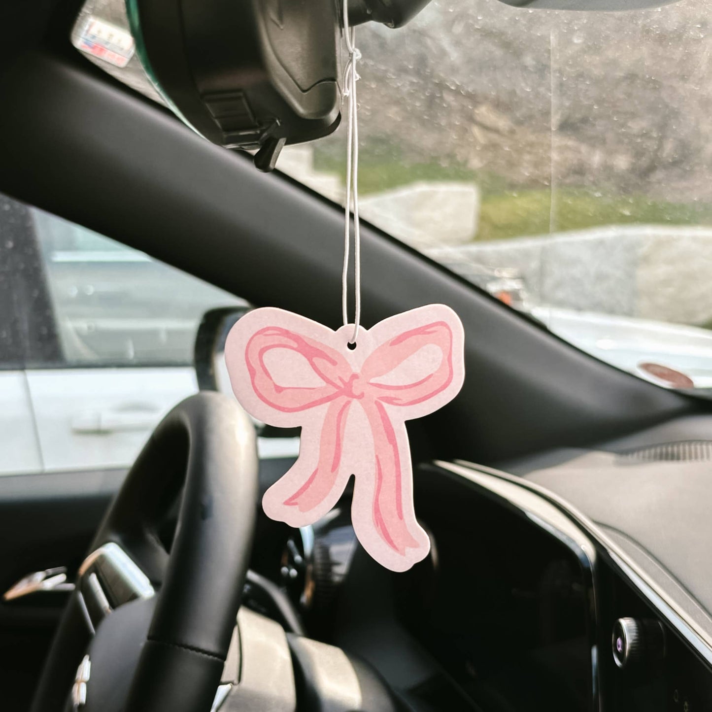 Sweet Ride Car Air Freshener–Bow Pink hangs from mirror; available in small and large sizes; delivers long-lasting fragrance.