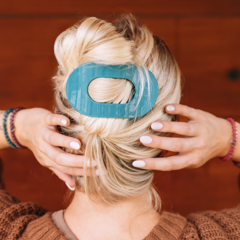 Teal With It Large Flat Round Hair Clip securing twisted blonde hair; available in multiple sizes.