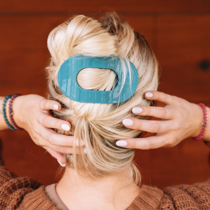 Teal With It Large Flat Round Hair Clip securing twisted blonde hair; available in multiple sizes.