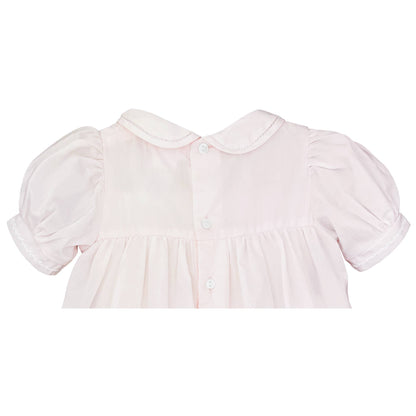 Pink baby dress, pintucks, featherstitch cuffs, puffed sleeves, 3 white back buttons; sizes: newborn–24 months.