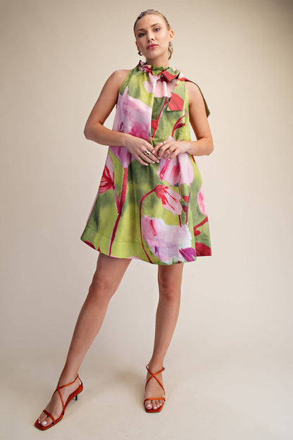 Mini Dress Ruffle Neck Tie Sleeveless Floral Print in Royal; bold pink florals on green, high ruffled neckline. Sizes: M.