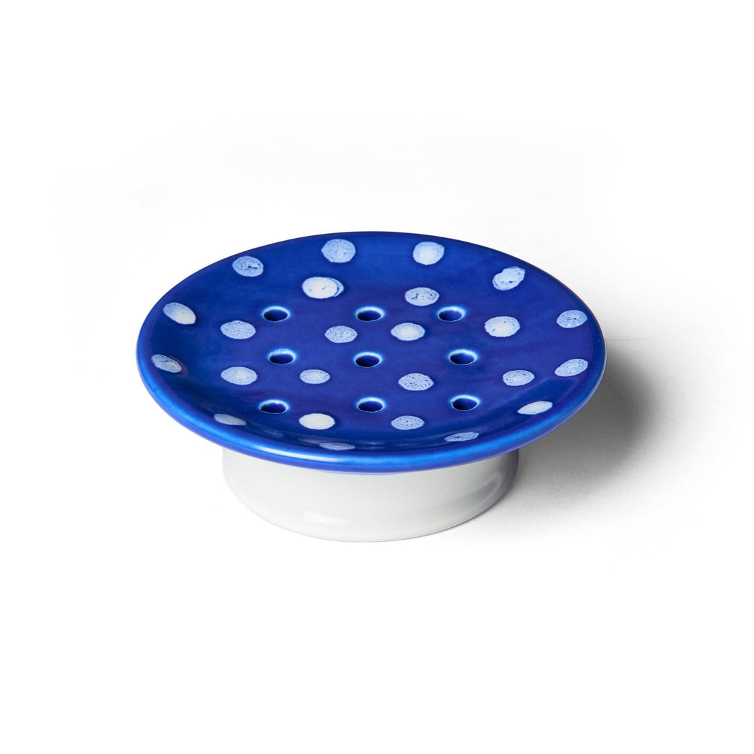 Blue ceramic soap dish with white polka dots, drainage holes, and a white base. Available in small and large sizes.