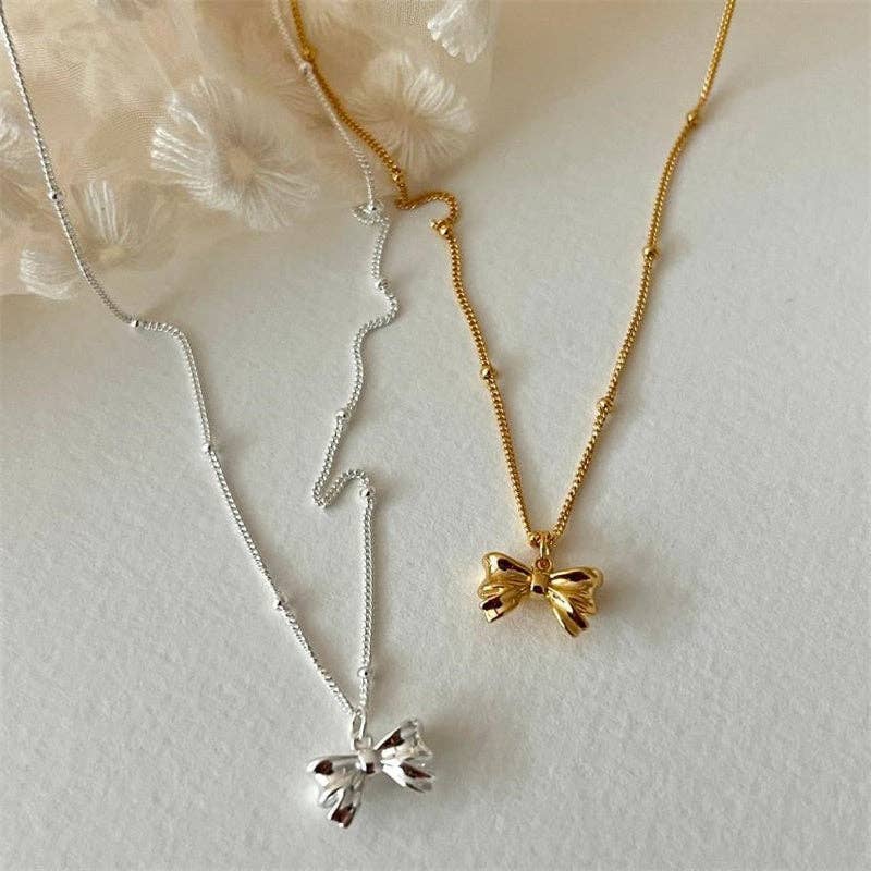 Dainty Bow Tie Bowknot Charm Necklace in 925 Sterling Silver with a delicate bow pendant, available in 16", 18", and 20" sizes.