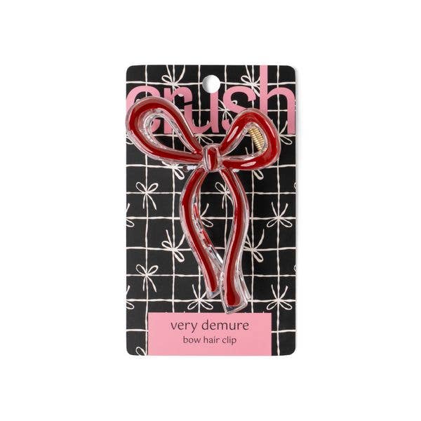 Red Crush Very Demure Bow Hair Clip, bow-shaped, easy to style. Available sizes not specified. Comes on branded grid card.