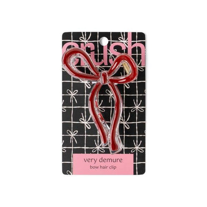 Red Crush Very Demure Bow Hair Clip, bow-shaped, easy to style. Available sizes not specified. Comes on branded grid card.