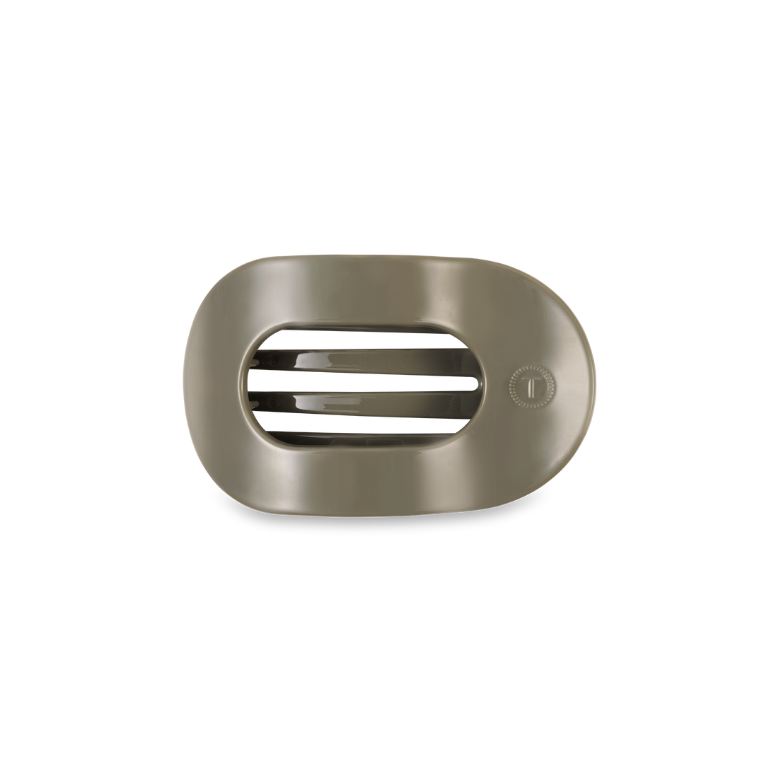 Metallic rectangular hair clip with horizontal slats and circular dial. Available in assorted sizes.