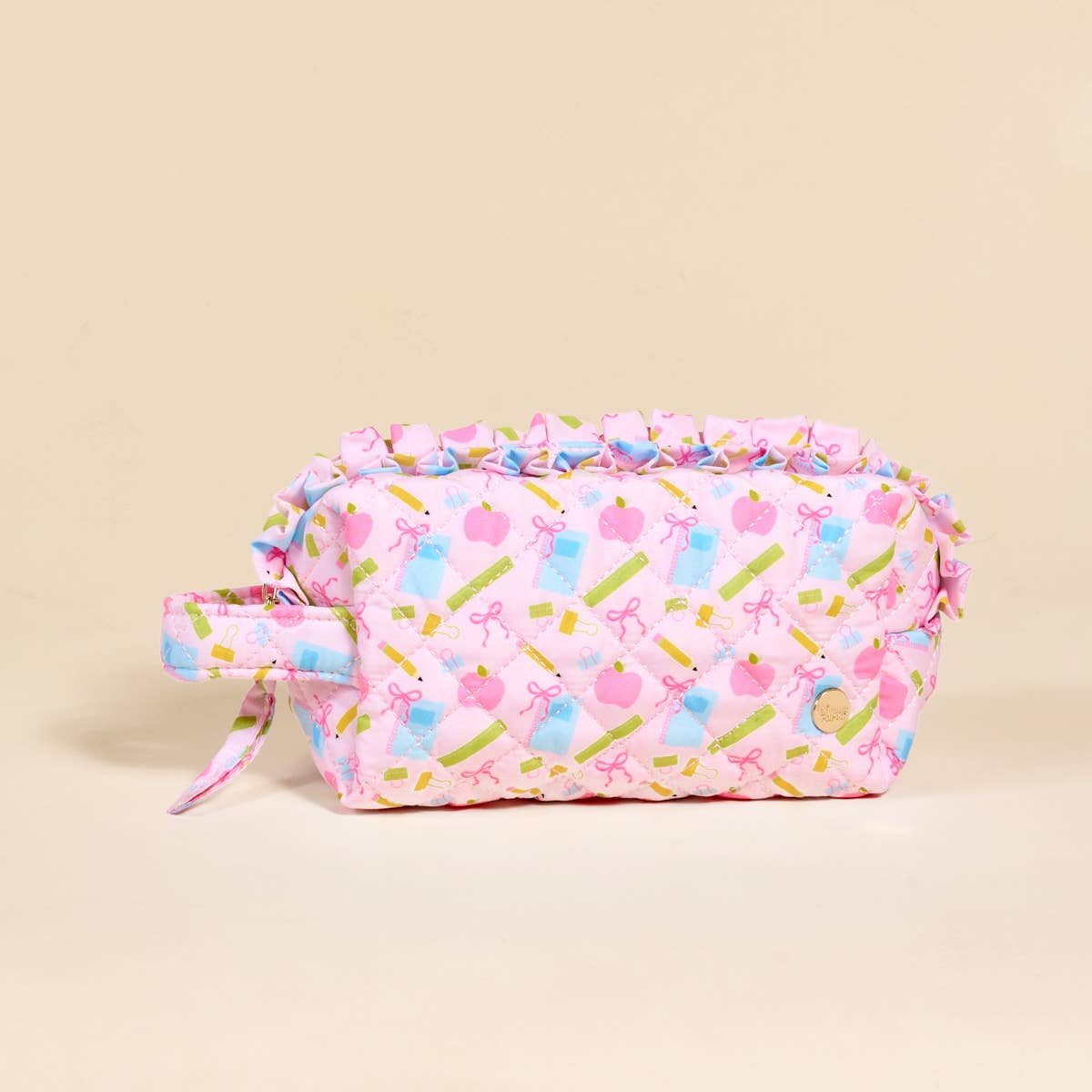 Rectangular pink quilted pouch with handle, ruffled edge, school-themed print on beige, wipeable lining. Sizes: not specified.