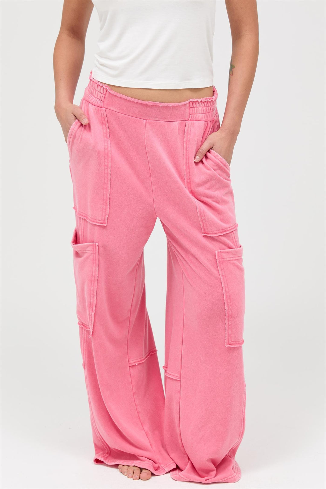 Bright pink Mineral Wash Wide Leg Cargo Pants with large side pockets; available in XS–XL.