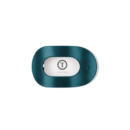Teal With It Small Flat Round Hair Clip holder with a teal oval design, transparent window showing the white Teleties logo, and a small button on the right side. Available in small size.