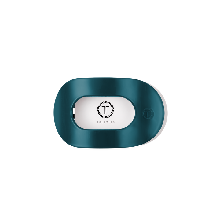 Teal With It Small Flat Round Hair Clip holder with a teal oval design, transparent window showing the white Teleties logo, and a small button on the right side. Available in small size.