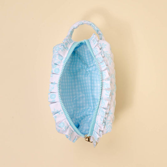 Light blue and white quilted pouch with ruffled edge, top handle, zipper, blue gingham lining. Sizes available: small, large.