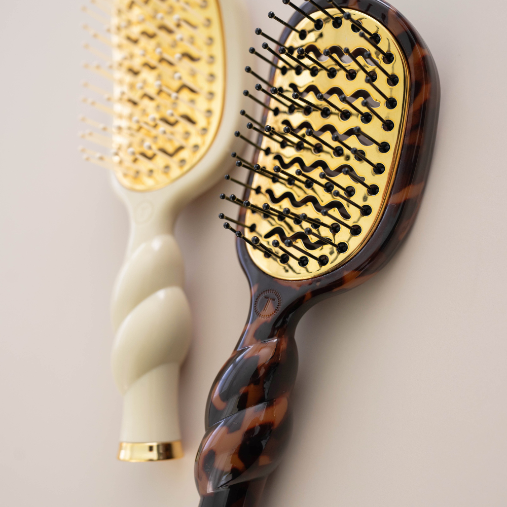 Mini Vented Brush | Tortoise features a classic tortoiseshell pattern with gold bristles and a twisted handle. Compact, ideal for travel or heat styling. Available in mini size.