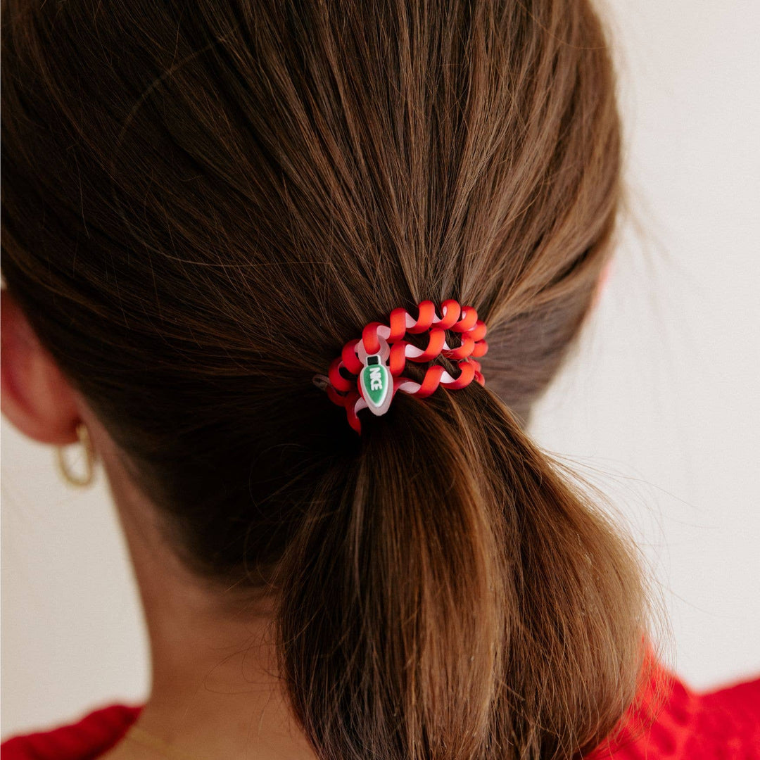 Red Spiral Hair Coil with small white charm and green text, available in the Naughty or Nice Hair Ties (Small) sizes.