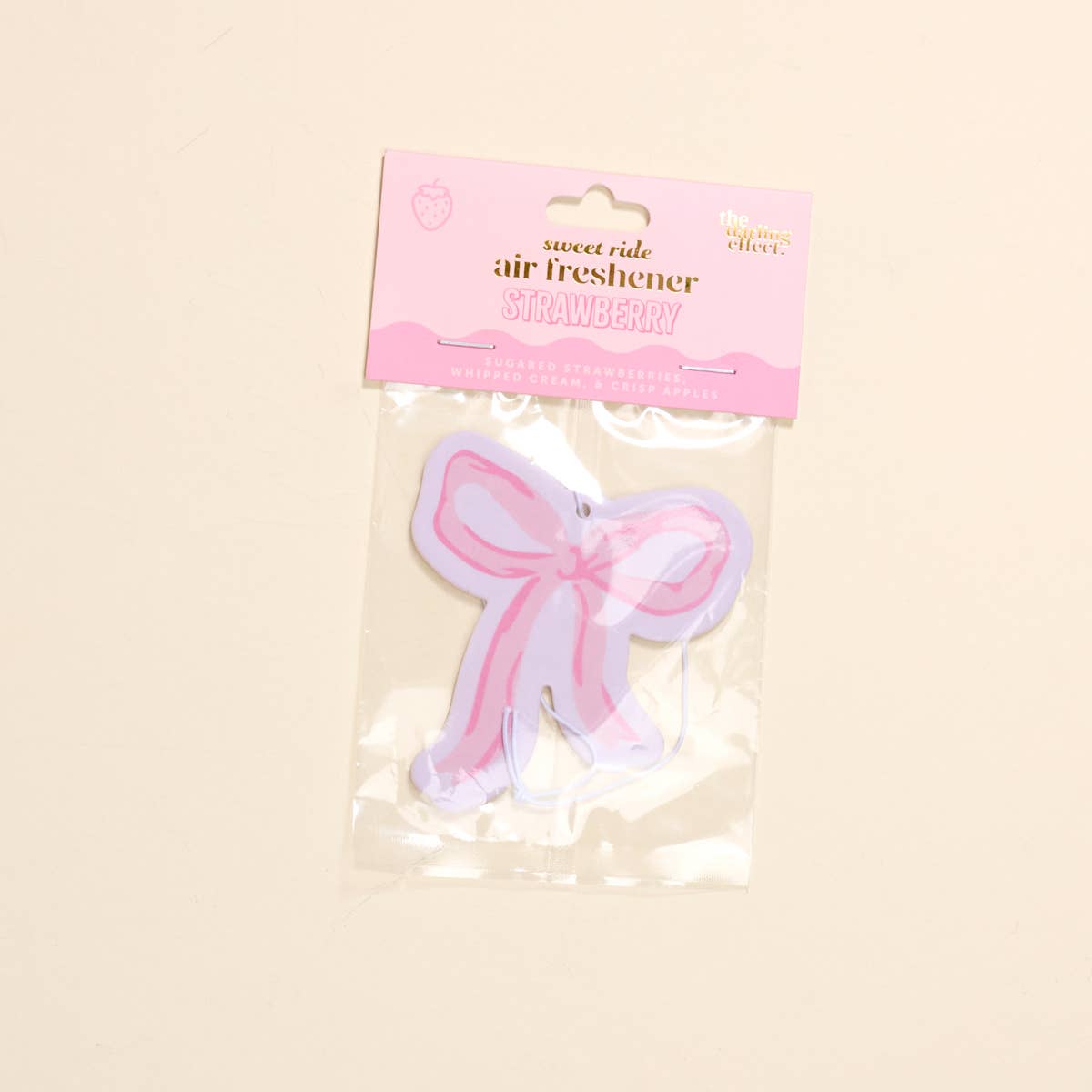 Sweet Ride Car Air Freshener–Bow Pink: pink bow shape, clear packaging, pink "STRAWBERRY" label. Size options available.