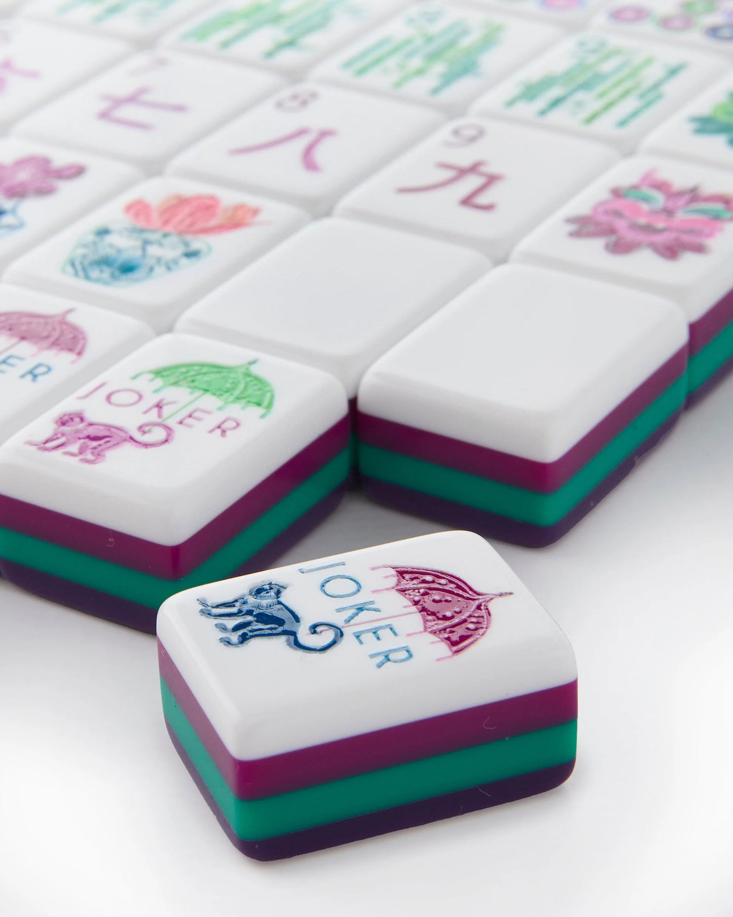 Gemma Mahjong Tiles, featuring a vibrant "JOKER" tile with monkey and parasol. Available in standard and large sizes.