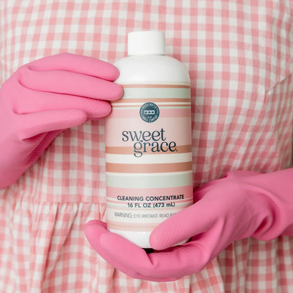 Sweet Grace Cleaning Concentrate bottle with a white and pink label featuring silver accents. Available in 16 oz and 32 oz sizes.