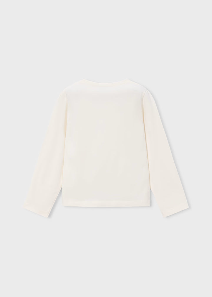 Back view of off-white long sleeve T-shirt with bow. Available in sizes 2T to 6X.