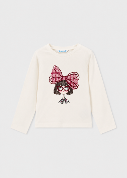 White long sleeve t-shirt with front graphic of cartoon girl, red glasses, and a big red bow. Available in multiple sizes.