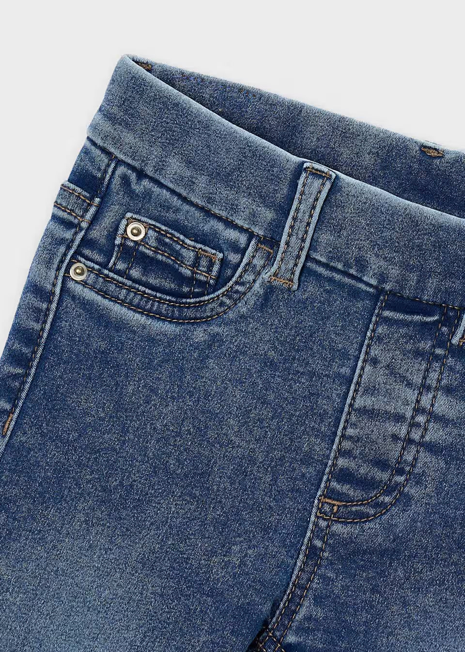 Light blue Little Girl Denim Skinny Fit Jeans, close-up of waistband, front pocket, coin pocket, visible stitching and metal rivets. Available in sizes 4-12.
