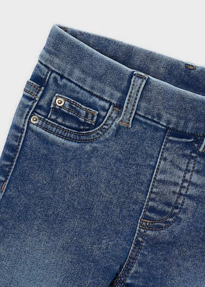 Light blue Little Girl Denim Skinny Fit Jeans, close-up of waistband, front pocket, coin pocket, visible stitching and metal rivets. Available in sizes 4-12.