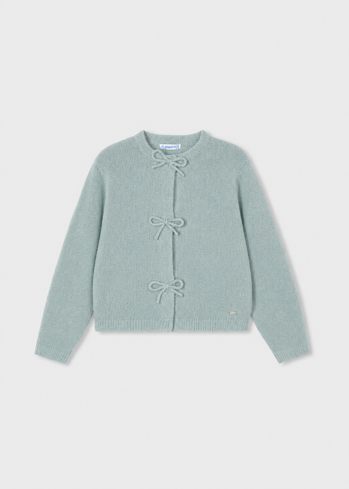Light blue long-sleeve cardigan with three front bow closures, crew neckline, and small metallic logo tag near the hem. Available in sizes 2T-6X.
