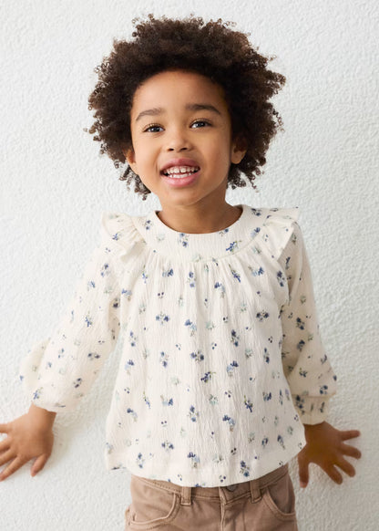 Little Girl Printed Crinkle Cotton Blouse in cream with blue floral prints and ruffle accents; available in sizes 2T-6T.