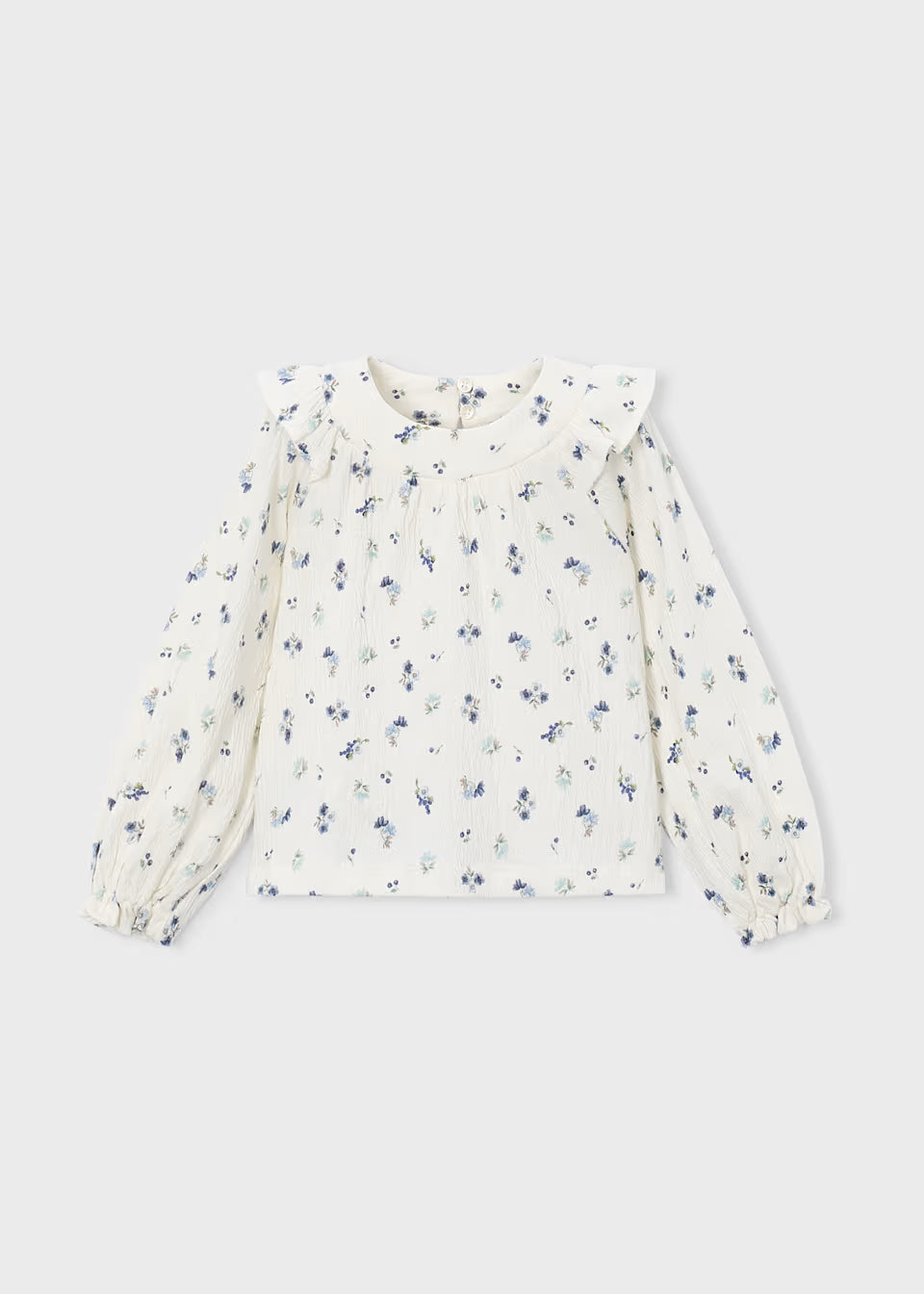 White crinkle cotton blouse with long sleeves, ruffled collar, small blue floral print, front pleats, ruffle accents, and elastic cuffs. Available in sizes 2T-6X.