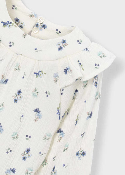 Little Girl Printed Crinkle Cotton Blouse with blue and green floral prints, ruffled shoulders, two white buttons at collar. Available in sizes 2T-6T.