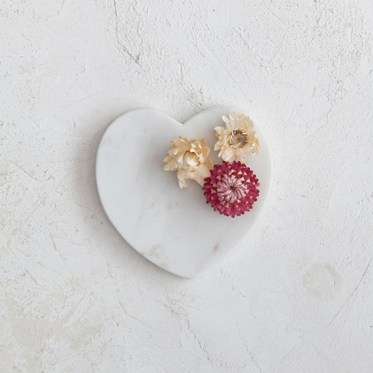 Marble heart-shaped dish with textured white surface, two cream and one pink dried flower. Available in small and large sizes.
