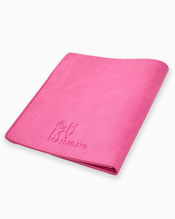 Folded hot pink faux leather Mahjong Card Folio with "OH MY MAHJONG" embossed. Available in one size.