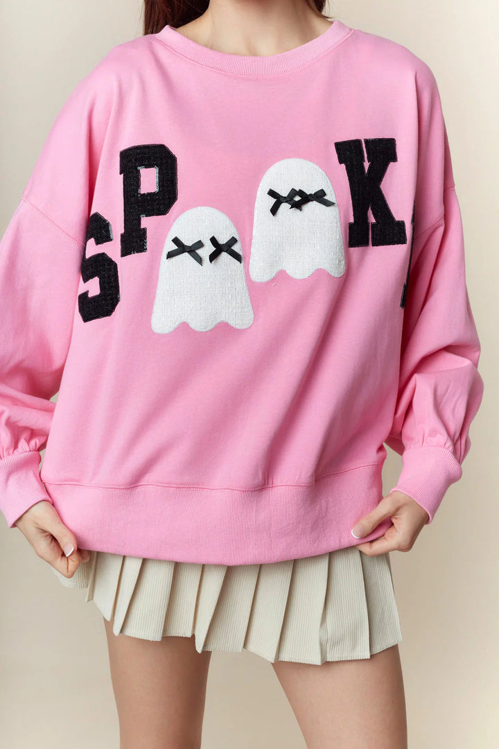 Spooky Boo Pink Patch Sweatshirt: oversized pink pullover with black “SPOOK” lettering and two cartoon ghost patches. Available in S, M, L, XL.
