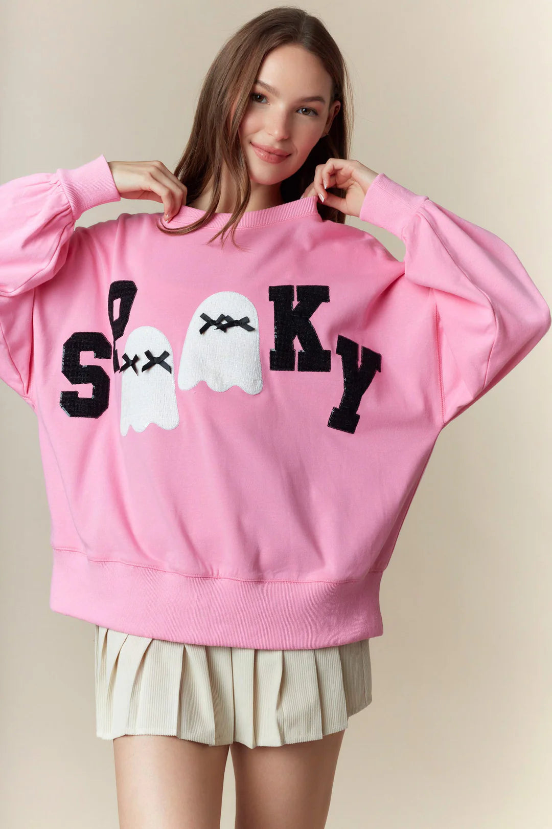 Spooky Boo Pink Patch Sweatshirt: oversized pink sweatshirt with ghost graphics, lace ghost patches, and bold “SPOOKY” lettering; available in sizes S-XL.
