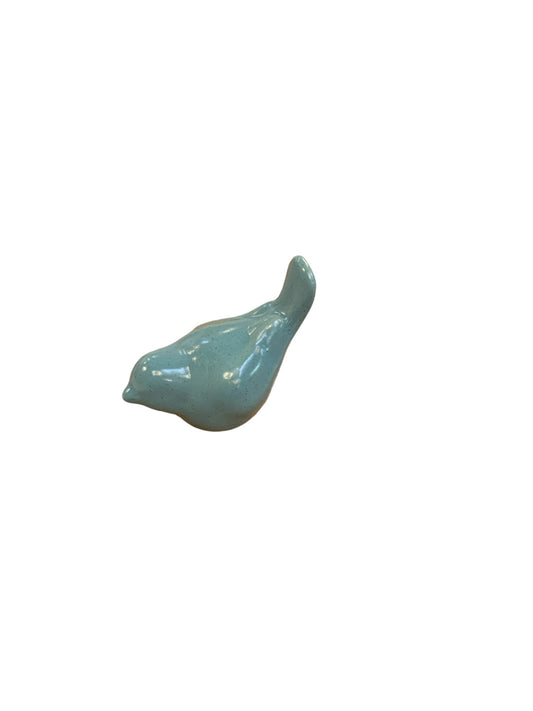 This Aqua Birds ceramic bird figurine is small and features a sleek, abstract shape. The design is distinctively crafted with a vibrant aquamarine color that enhances its aesthetic appeal. It comes in one standard size to fit your decor needs perfectly.