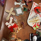 Assorted holiday ornaments: crosses, cowboy boot, reindeer, heart, tree, balls, skates, plaque. Sizes: small to large.