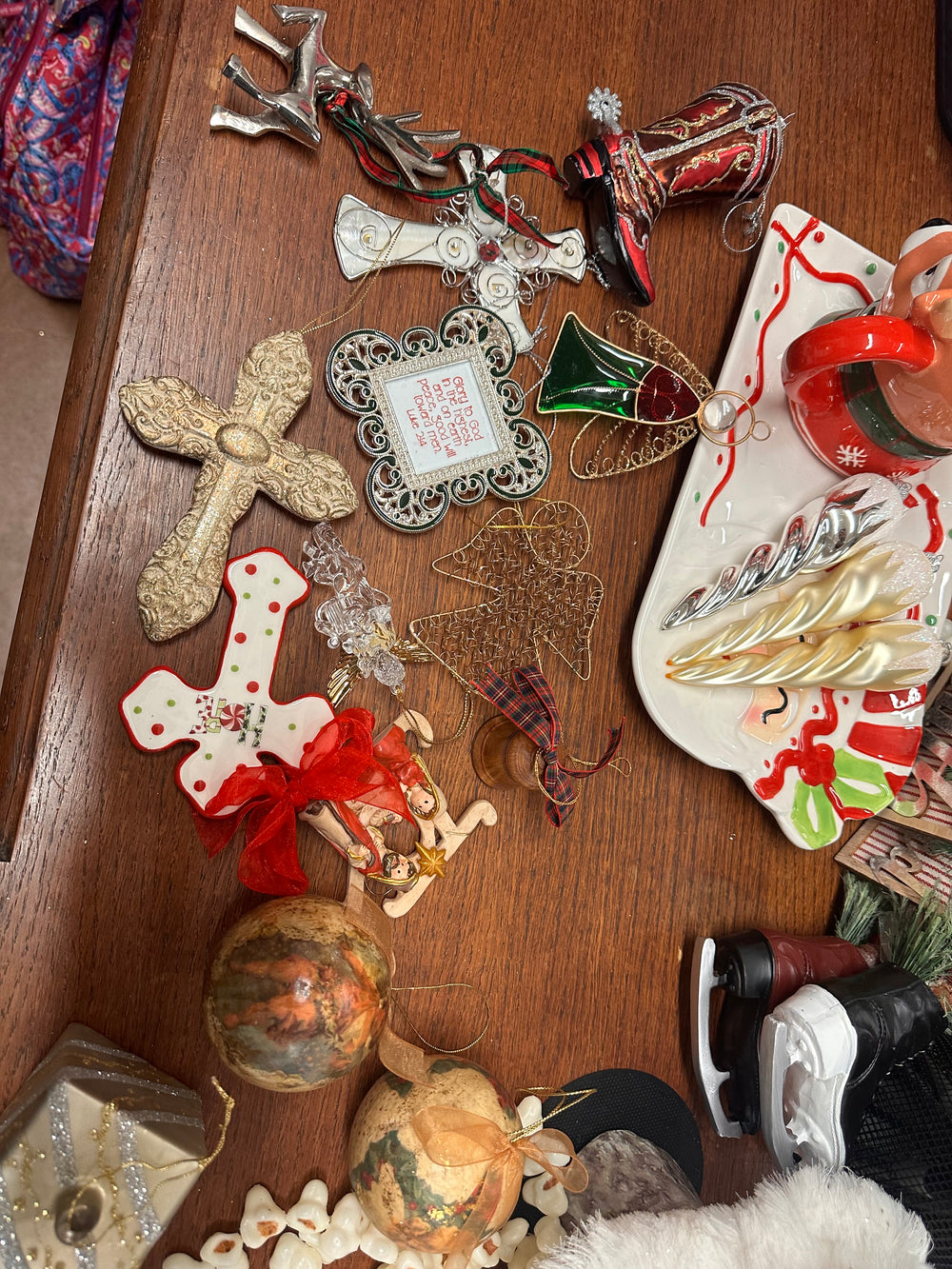 Assorted holiday ornaments: crosses, cowboy boot, reindeer, heart, tree, balls, skates, plaque. Sizes: small to large.