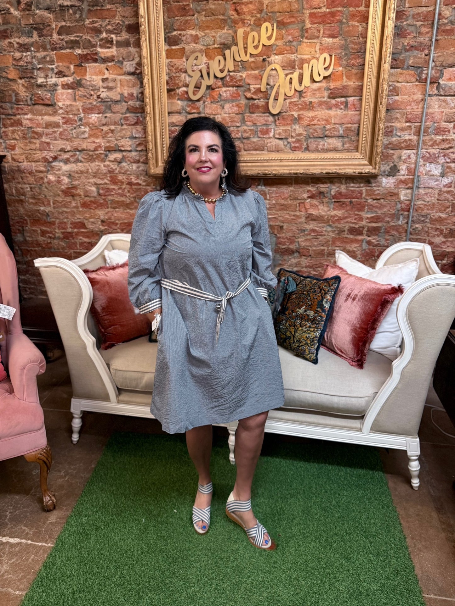 Denim textured mini dress with contrast trim and tie waist. Available in sizes XS-XL.